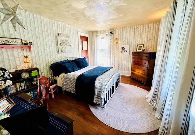 bedroom with dark wood-type flooring and a textured ceiling