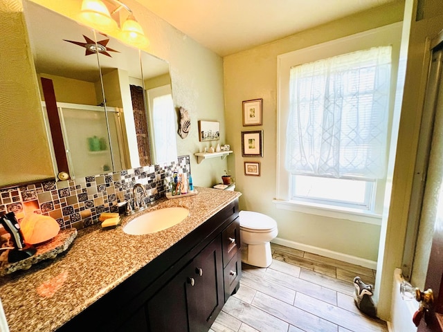 bathroom with hardwood / wood-style flooring, tasteful backsplash, toilet, an enclosed shower, and vanity