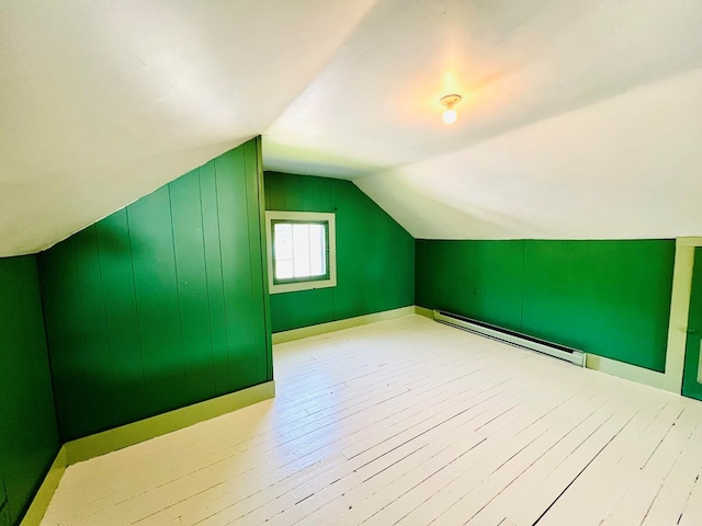 bonus room with light wood-type flooring, lofted ceiling, and baseboard heating