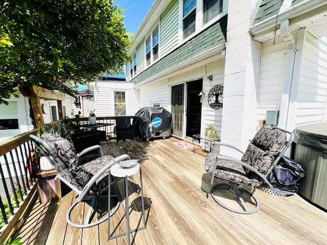 wooden terrace featuring a grill