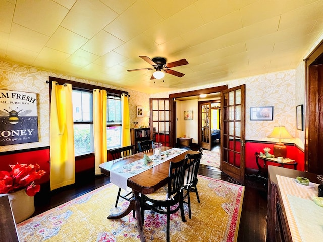 dining space with dark hardwood / wood-style flooring, ceiling fan, and french doors