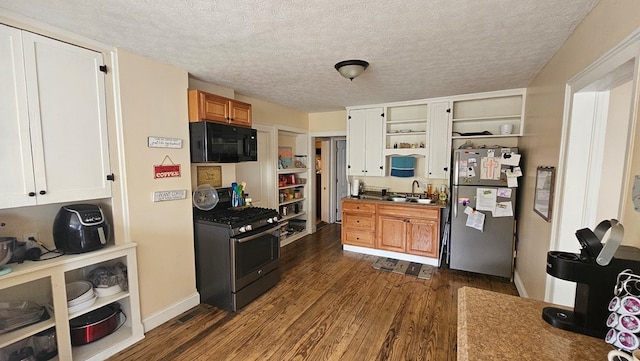 kitchen with a textured ceiling, sink, dark hardwood / wood-style floors, and appliances with stainless steel finishes