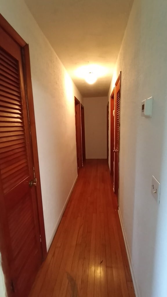 corridor featuring hardwood / wood-style floors