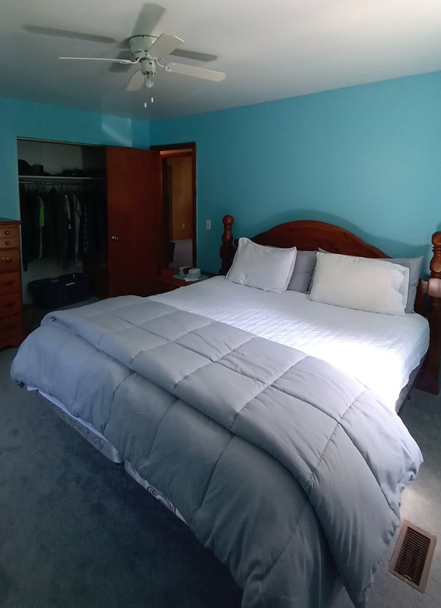 carpeted bedroom featuring ceiling fan and a closet