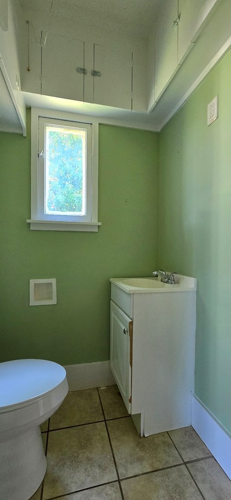 bathroom with tile patterned floors, vanity, and toilet