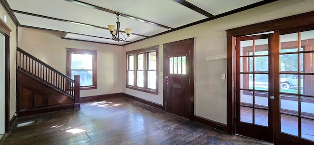 foyer entrance with dark hardwood / wood-style floors, french doors, and a chandelier