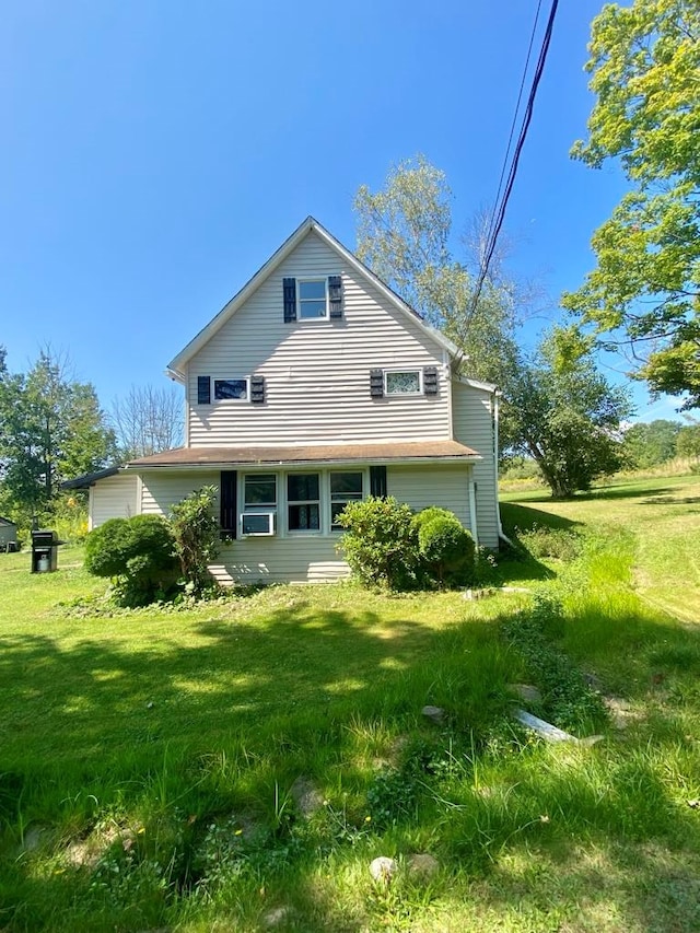 rear view of property with a yard