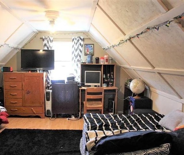 bedroom with lofted ceiling and wood-type flooring