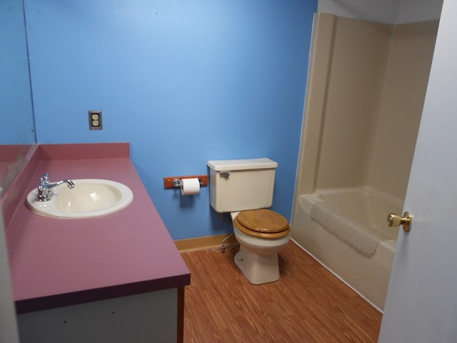 full bathroom featuring vanity, toilet, shower / bathtub combination, and hardwood / wood-style floors