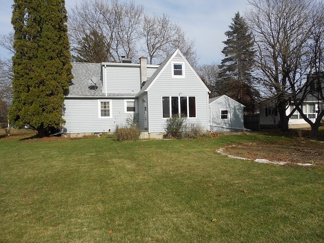 rear view of property with a yard