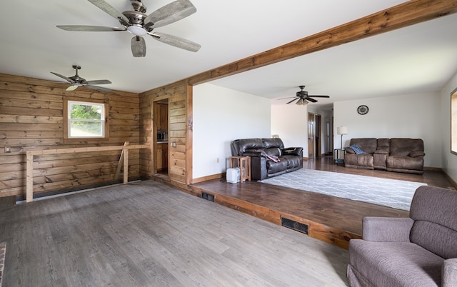 unfurnished living room featuring wood-type flooring and wooden walls