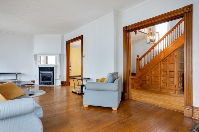 living room with ornamental molding, dark hardwood / wood-style floors, and a chandelier