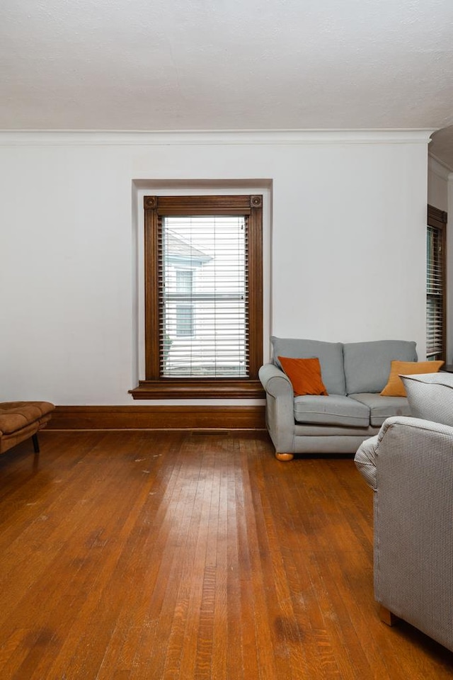 living room featuring hardwood / wood-style flooring and ornamental molding