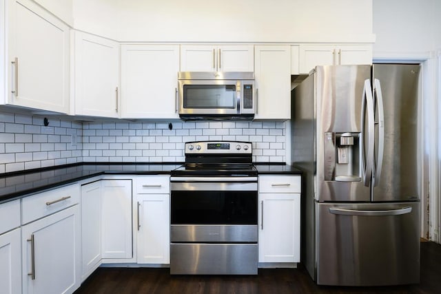 kitchen featuring tasteful backsplash, stainless steel appliances, dark wood-type flooring, and white cabinets