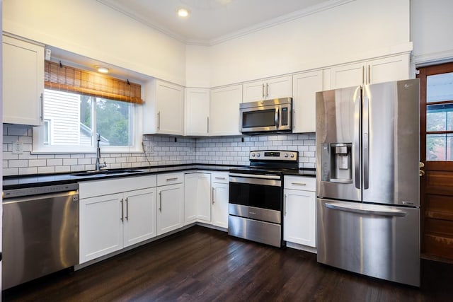 kitchen featuring sink, stainless steel appliances, ornamental molding, white cabinets, and dark hardwood / wood-style flooring