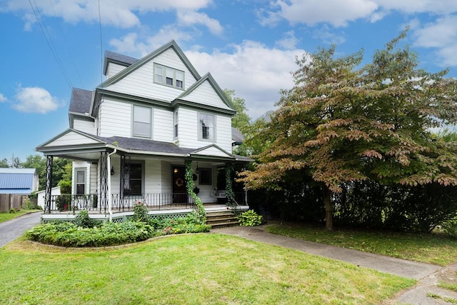 view of front of home with a front yard and covered porch