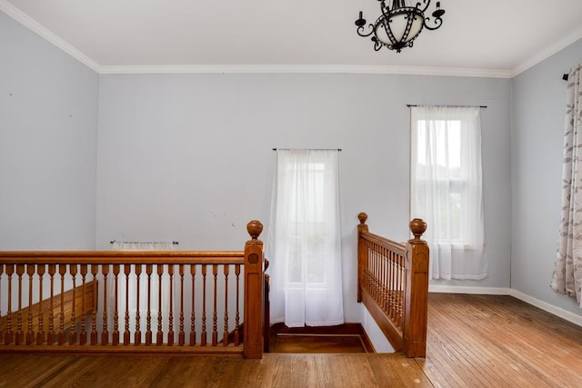 interior space featuring crown molding, hardwood / wood-style floors, and an inviting chandelier