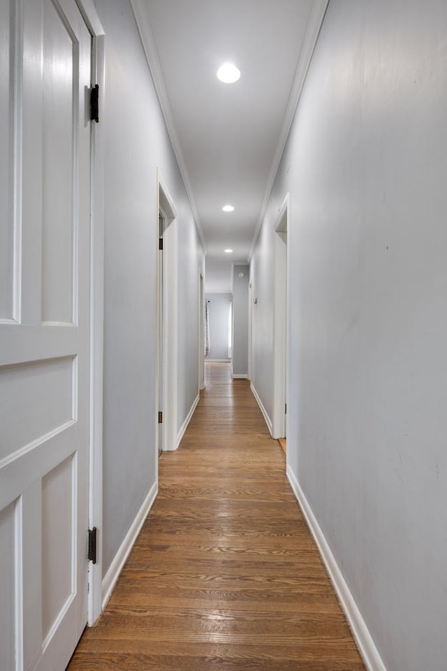 hall with crown molding and hardwood / wood-style floors