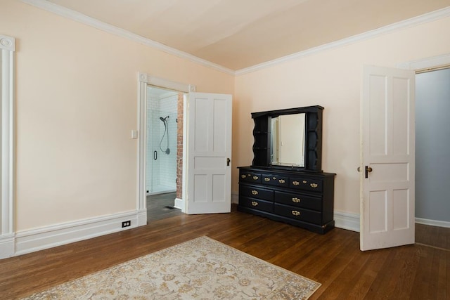 bedroom with ornamental molding, dark hardwood / wood-style floors, and connected bathroom