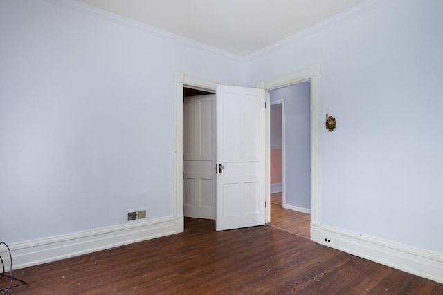 unfurnished bedroom featuring ornamental molding and dark hardwood / wood-style flooring