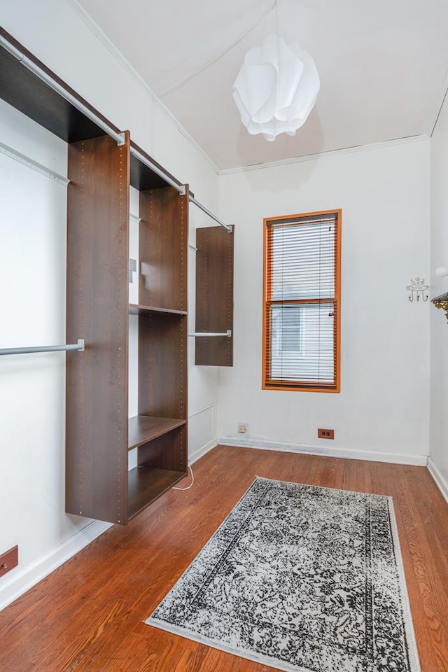 bedroom featuring hardwood / wood-style flooring and crown molding