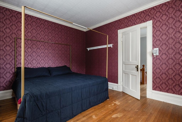 unfurnished bedroom with crown molding and wood-type flooring