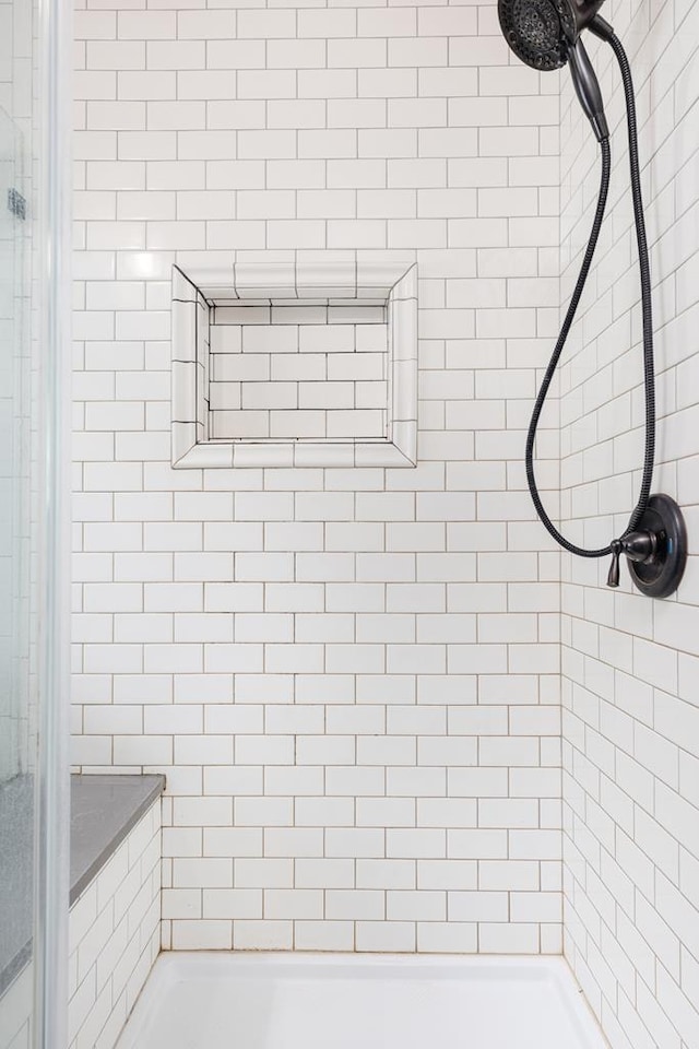 bathroom with a tile shower