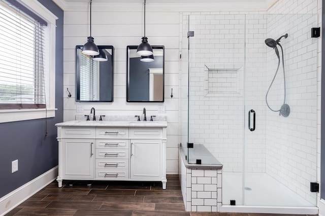 bathroom with walk in shower, vanity, and crown molding