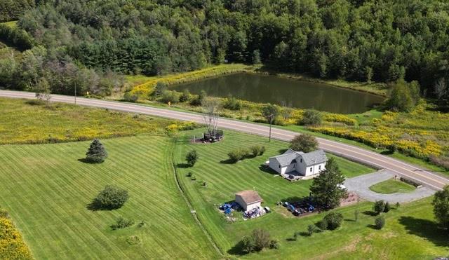 drone / aerial view with a water view and a rural view