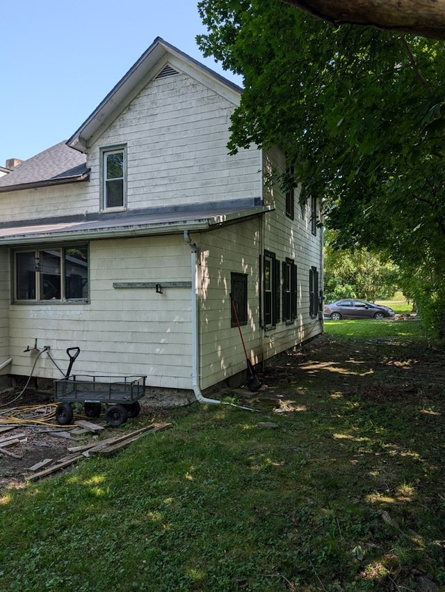 view of property exterior with a yard