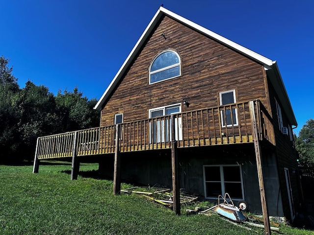 back of house with a deck and a lawn