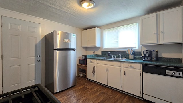 kitchen with stainless steel fridge, white cabinets, dark wood-type flooring, sink, and dishwasher