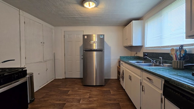 kitchen with sink, dark hardwood / wood-style floors, stainless steel fridge, a textured ceiling, and white cabinetry