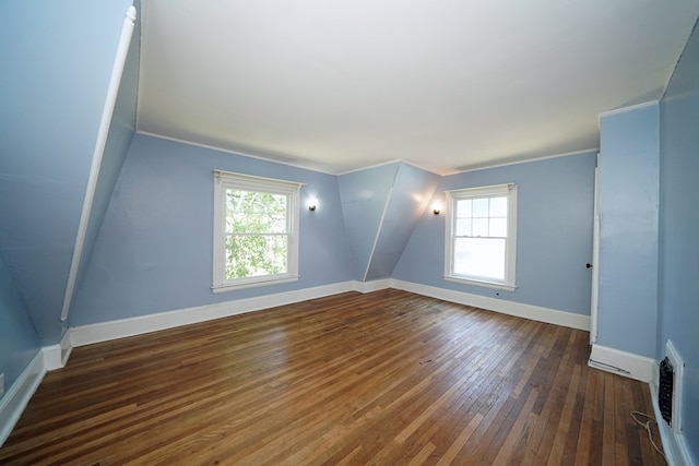 empty room with a wealth of natural light, dark hardwood / wood-style floors, and ornamental molding