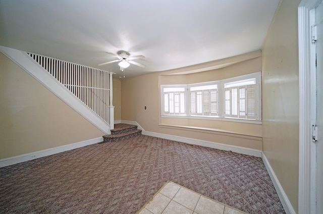 empty room featuring light carpet and ceiling fan