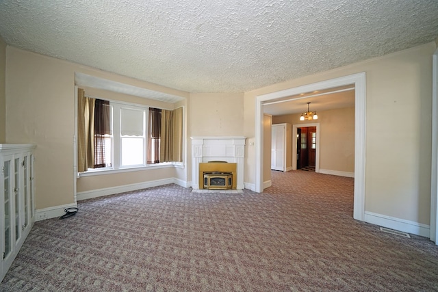 unfurnished living room with a chandelier, a textured ceiling, and carpet flooring