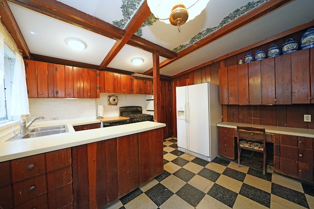 kitchen with gas stove, tasteful backsplash, white refrigerator with ice dispenser, sink, and beamed ceiling