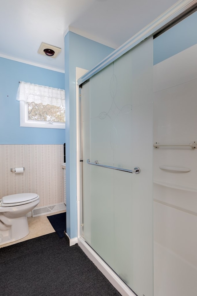 bathroom featuring toilet and walk in shower