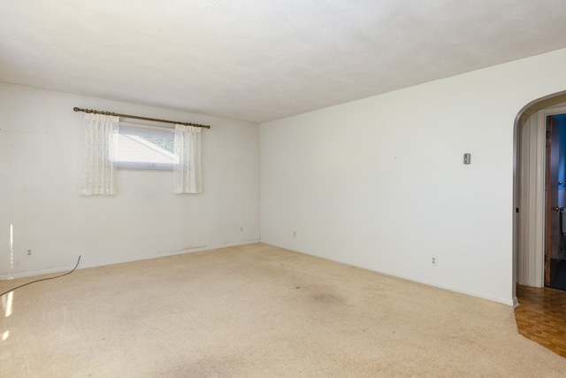 spare room with a textured ceiling and carpet