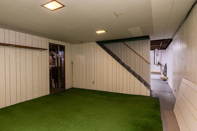 basement featuring wood walls