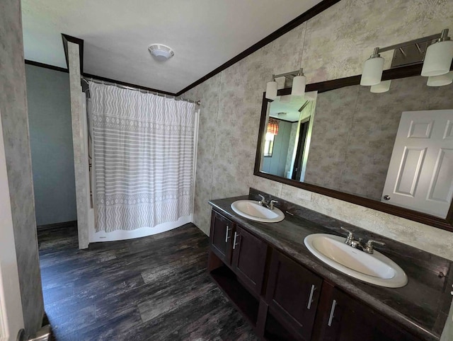 bathroom featuring a healthy amount of sunlight, vanity, hardwood / wood-style flooring, and ornamental molding