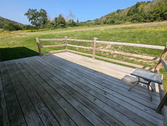 wooden terrace featuring a lawn