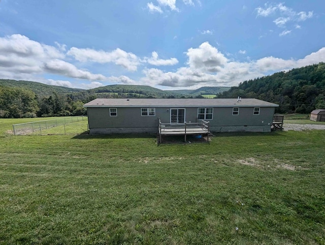 rear view of property with a lawn and a mountain view