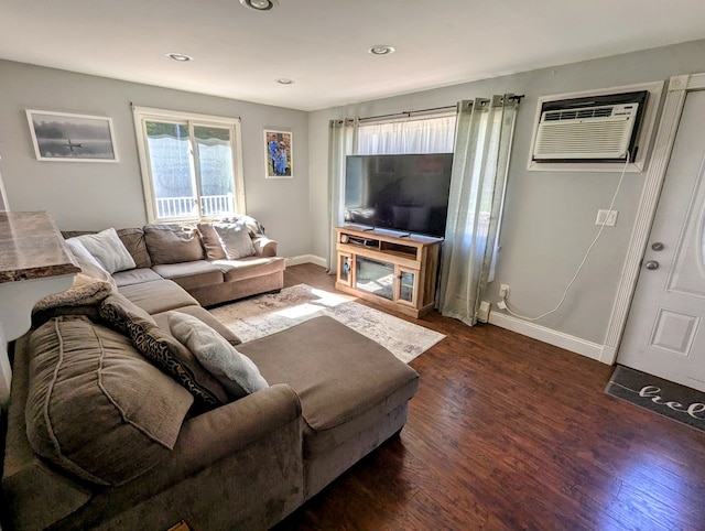 living room featuring a wall mounted air conditioner and dark hardwood / wood-style flooring