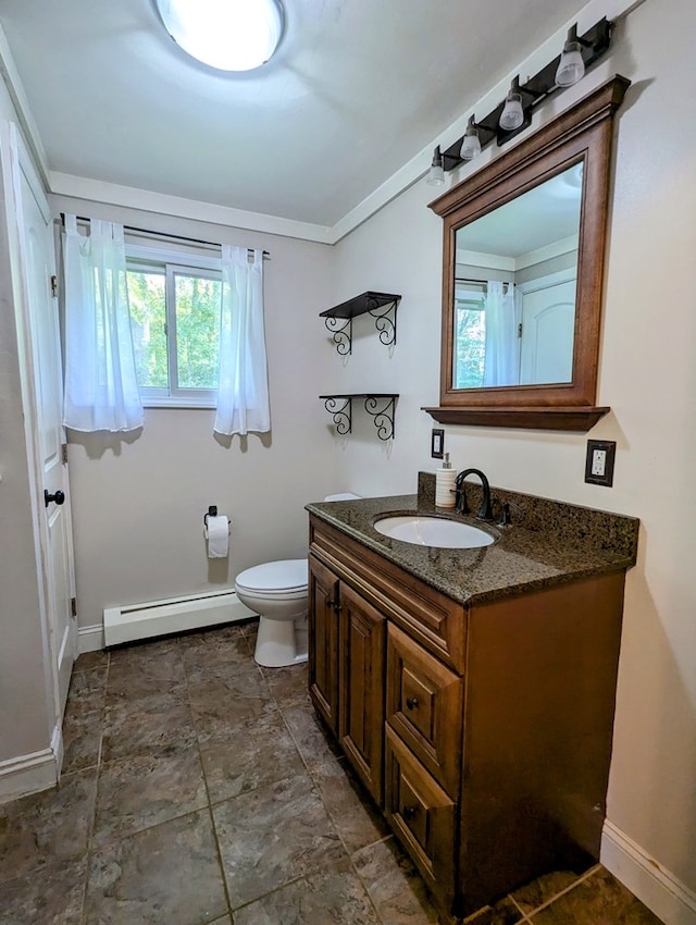 bathroom featuring vanity, ornamental molding, baseboard heating, and toilet