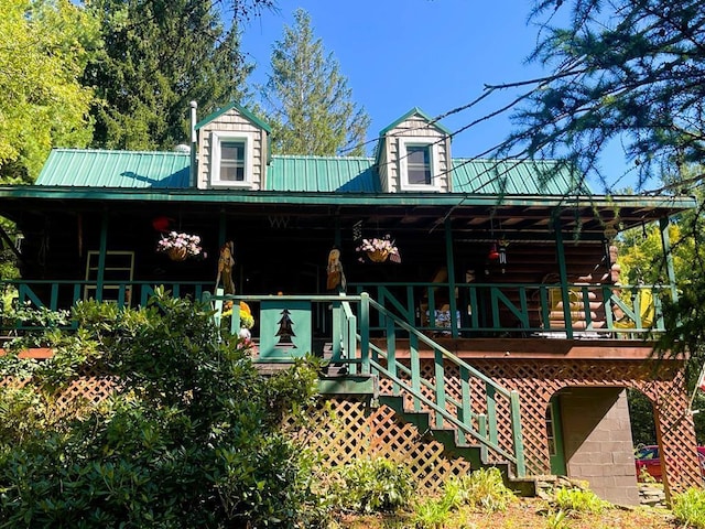 back of house featuring a porch