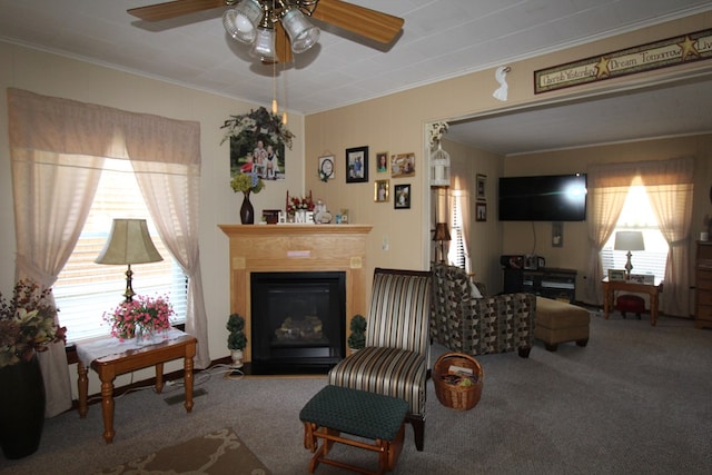 carpeted living room featuring ceiling fan and crown molding