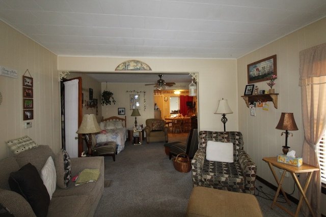 living room featuring ceiling fan and carpet