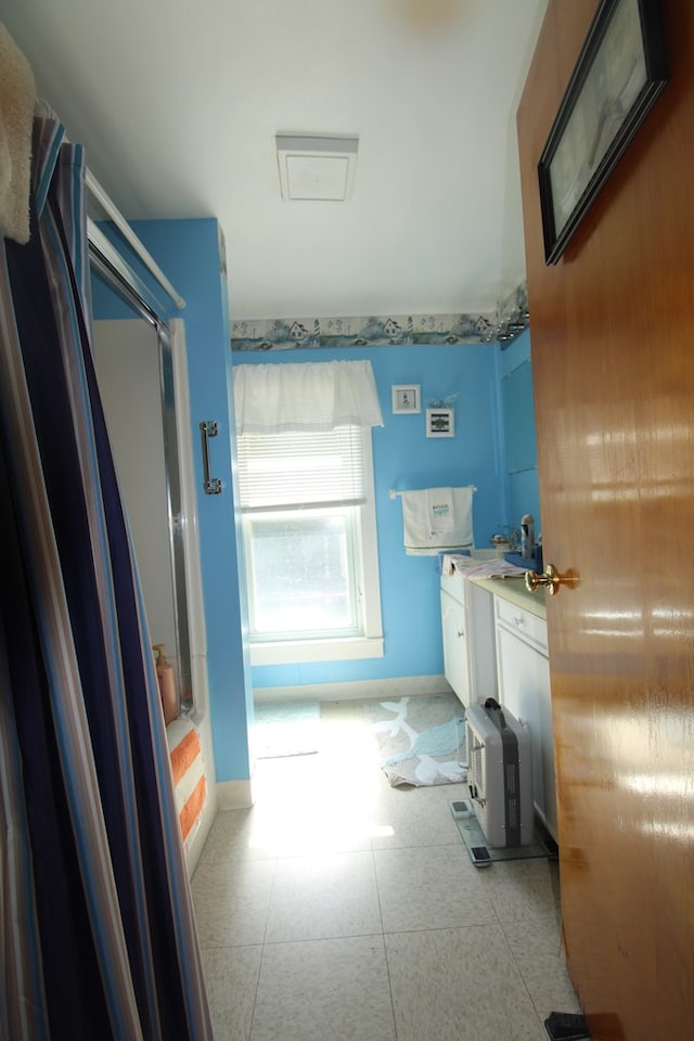 bathroom with vanity and washtub / shower combination