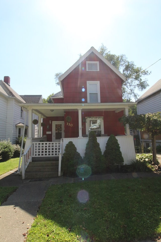 view of front facade with covered porch and a front lawn